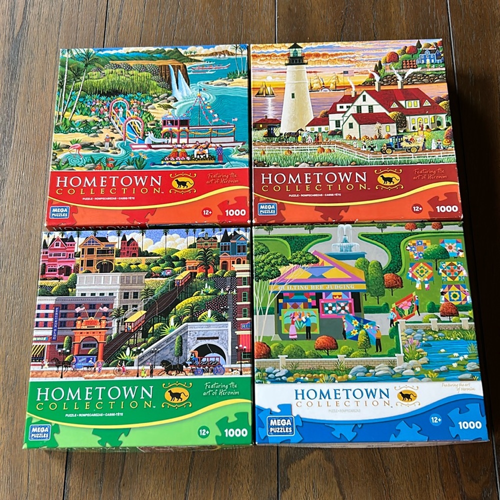 Four Hometown Collection 1000 piece puzzles featuring art by Heronim